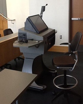 Modern style university iInstructor lectern with motorized monitor tilt and height adjustments.